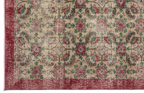 Load image 1 in gallery view. Beige rug with a distressed floral medallion pattern in red, green, and purple, featuring a solid red border.