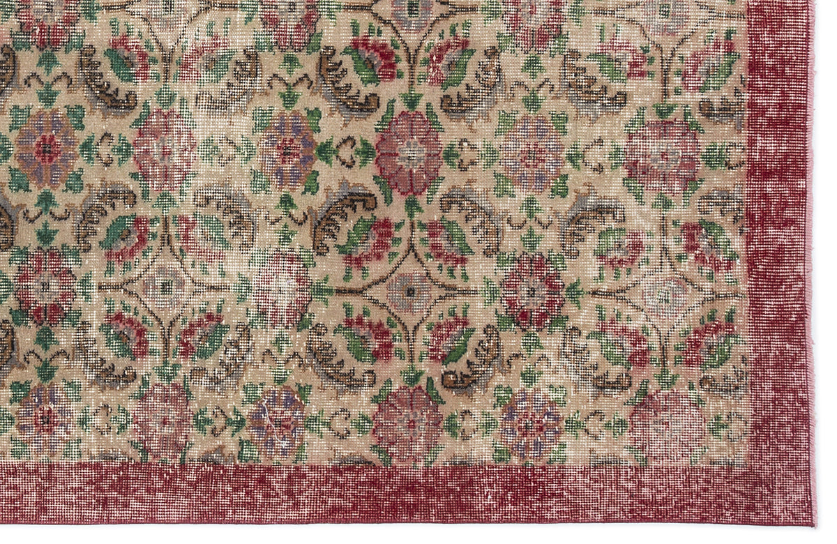 Beige rug with a distressed floral medallion pattern in red, green, and brown, featuring a solid red border.