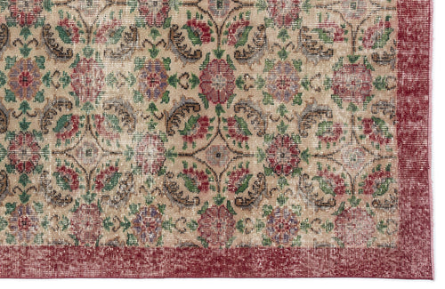 Load image 1 in gallery view. Beige rug with a distressed floral medallion pattern in red, green, and brown, featuring a solid red border.