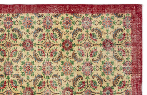 Load image 1 in gallery view. Beige rug with a red border and a repeating floral medallion pattern in red, green, and blue on a white background.
