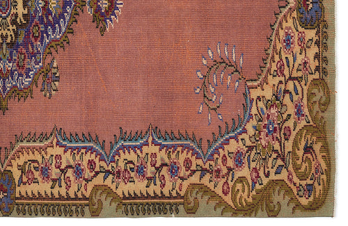 Load image 1 in gallery view. Dusty rose rug with a traditional floral border in blue, green, and cream, featuring intricate paisley-style motifs.