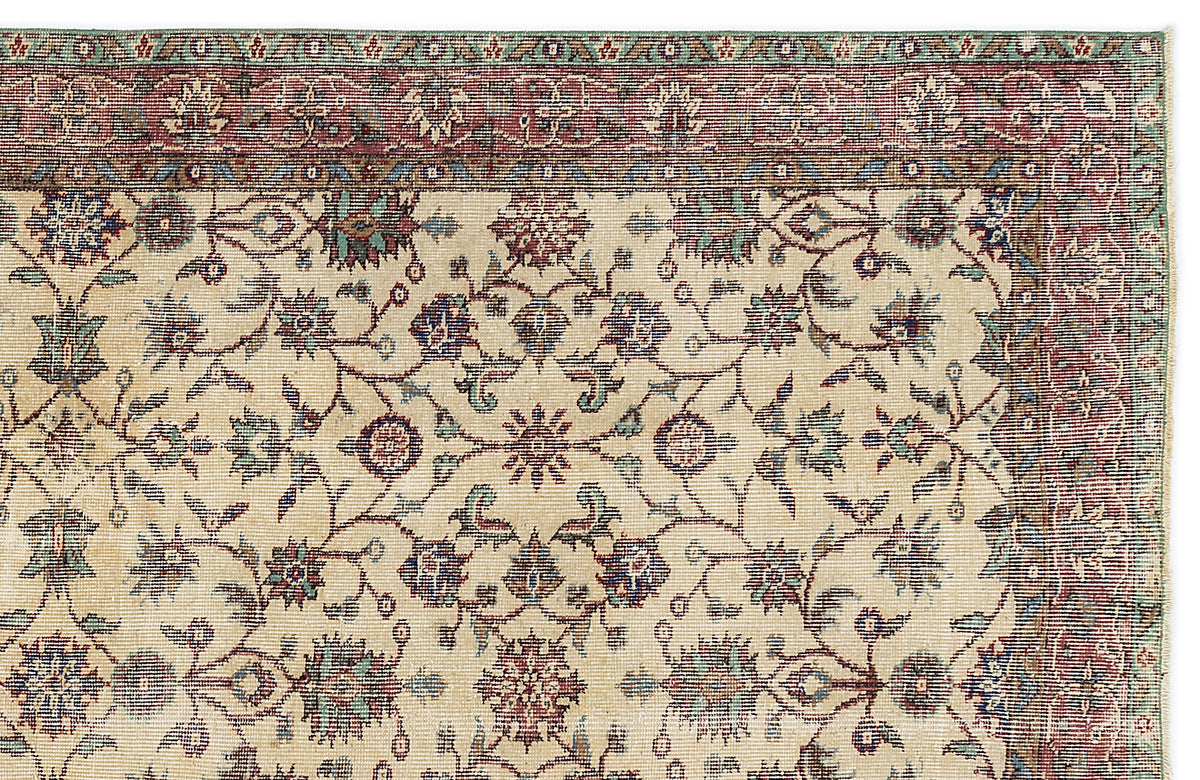 Beige traditional rug with a red, blue, and green floral vine pattern and a multi-layered decorative border.
