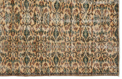 Load image 1 in gallery view. Tan, green, and rust-colored vintage-style rug with a repeating diamond lattice and floral medallion pattern.