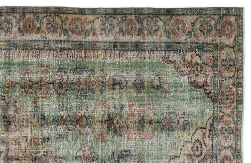 Load image 1 in gallery view. Distressed sage green rug with a faded traditional floral medallion pattern and a decorative border.