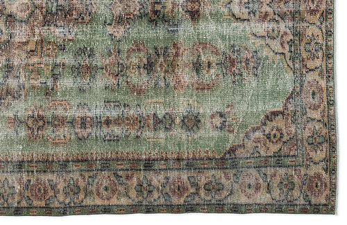 Load image 1 in gallery view. Distressed sage green rug with a traditional floral medallion pattern in brown and cream, isolated on a white background.