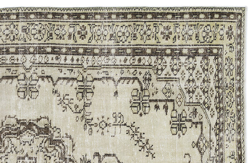 Load image 1 in gallery view. Beige and dark brown vintage-style rug with a distressed geometric and floral border pattern on a white background.