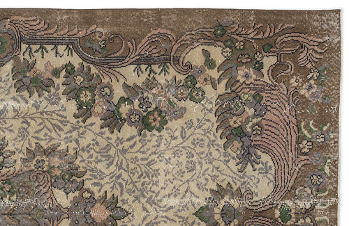 Load image 1 in gallery view. Distressed brown and beige rug with a floral vine pattern and ornate border.