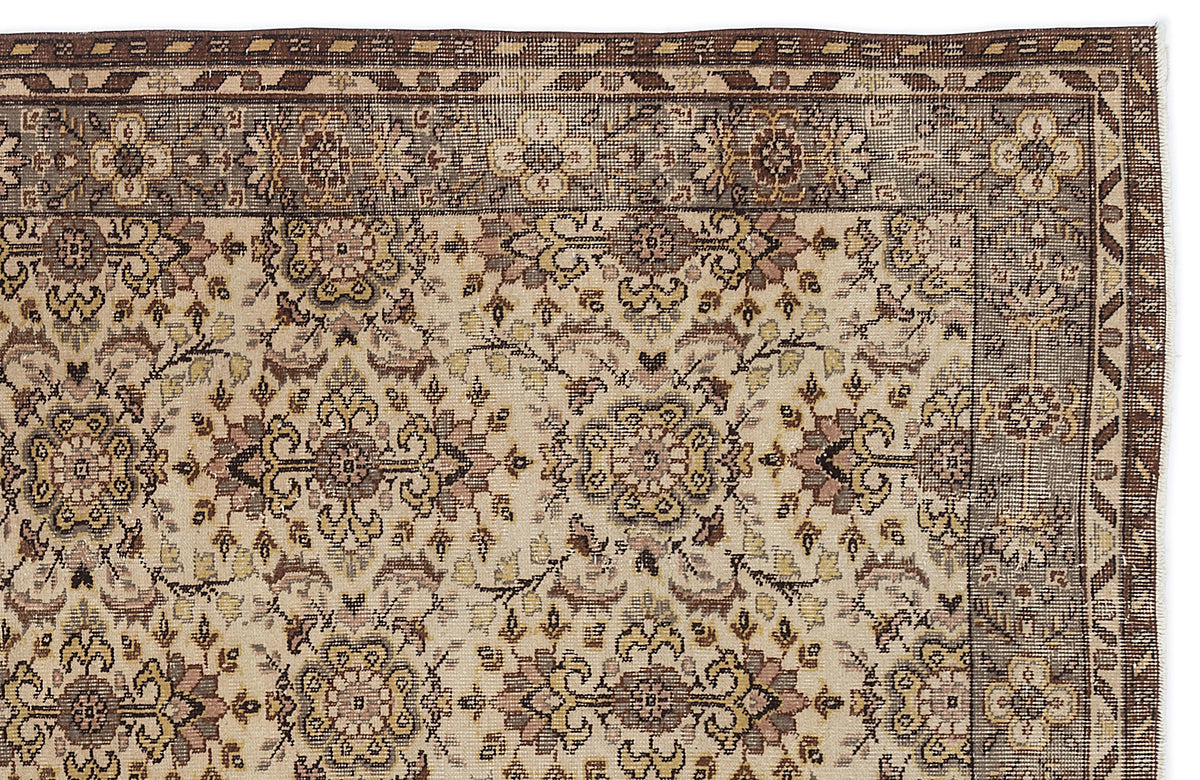 Beige and brown traditional rug with a floral medallion pattern and a geometric border.