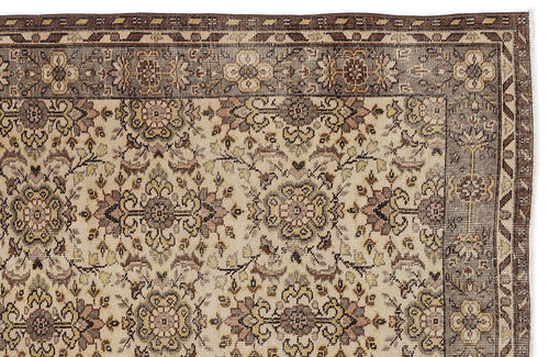 Load image 1 in gallery view. Beige and brown traditional rug with a floral medallion pattern and a geometric border.