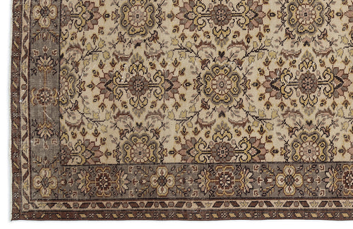 Load image 1 in gallery view. Beige rug with a brown floral medallion pattern and a wide, dark brown decorative border.