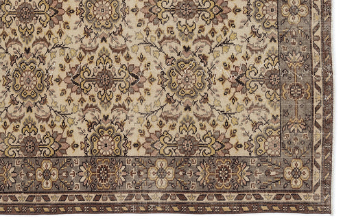 Load image 1 in gallery view. Beige traditional rug with a repeating floral medallion pattern in brown, gold, and muted pink, featuring a wide border.
