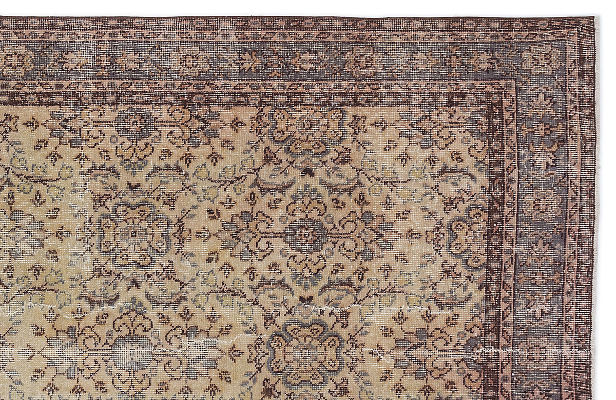 Beige and brown traditional rug with a distressed floral medallion pattern and a dark bordered edge.