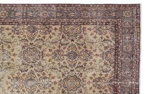 Load image 1 in gallery view. Beige and brown traditional rug with a distressed floral medallion pattern and a dark bordered edge.