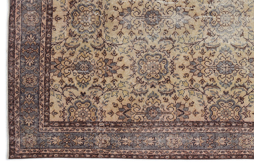 Load image 1 in gallery view. Beige and brown traditional rug with a distressed floral medallion pattern and a dark bordered edge.