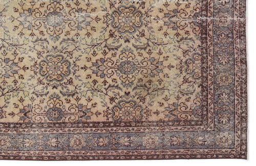 Load image 1 in gallery view. Beige and brown traditional rug with a distressed floral medallion pattern and a detailed border.