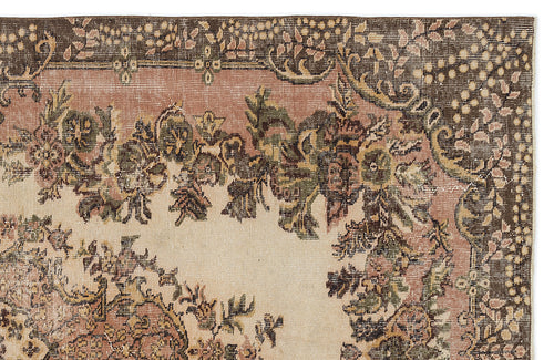 Load image 1 in gallery view. Vintage-style rug corner with a floral medallion pattern in muted brown, sage green, and dusty rose on a cream field.