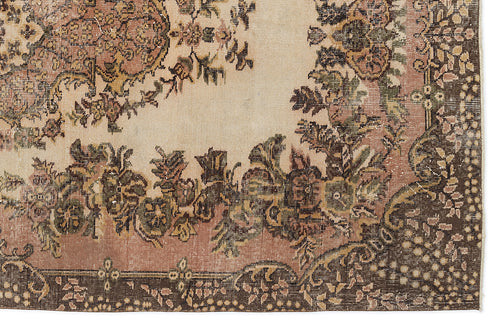 Load image 1 in gallery view. Distressed beige, pink, and brown rug with a traditional floral medallion pattern and ornate border.