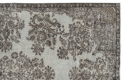 Load image 1 in gallery view. Light gray and charcoal distressed rug with a traditional floral medallion pattern and a dark decorative border.