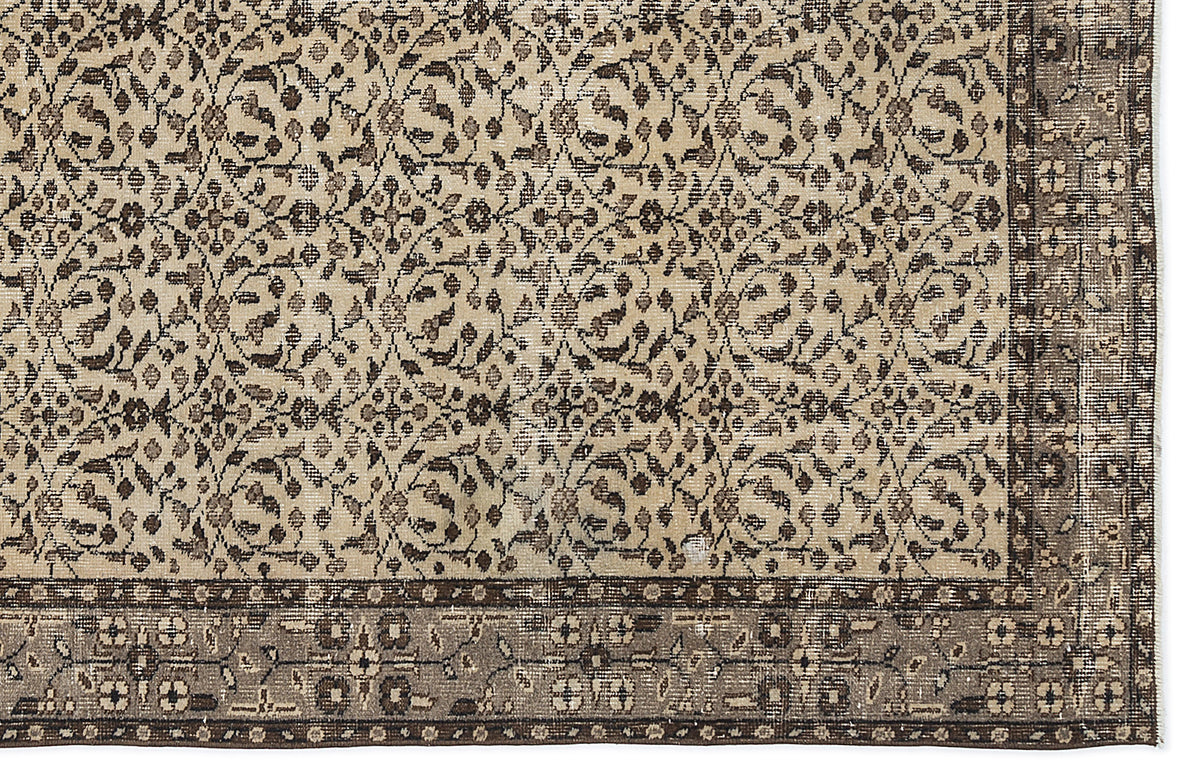 Beige and brown traditional rug with a dense floral vine pattern and a wide, ornate border.