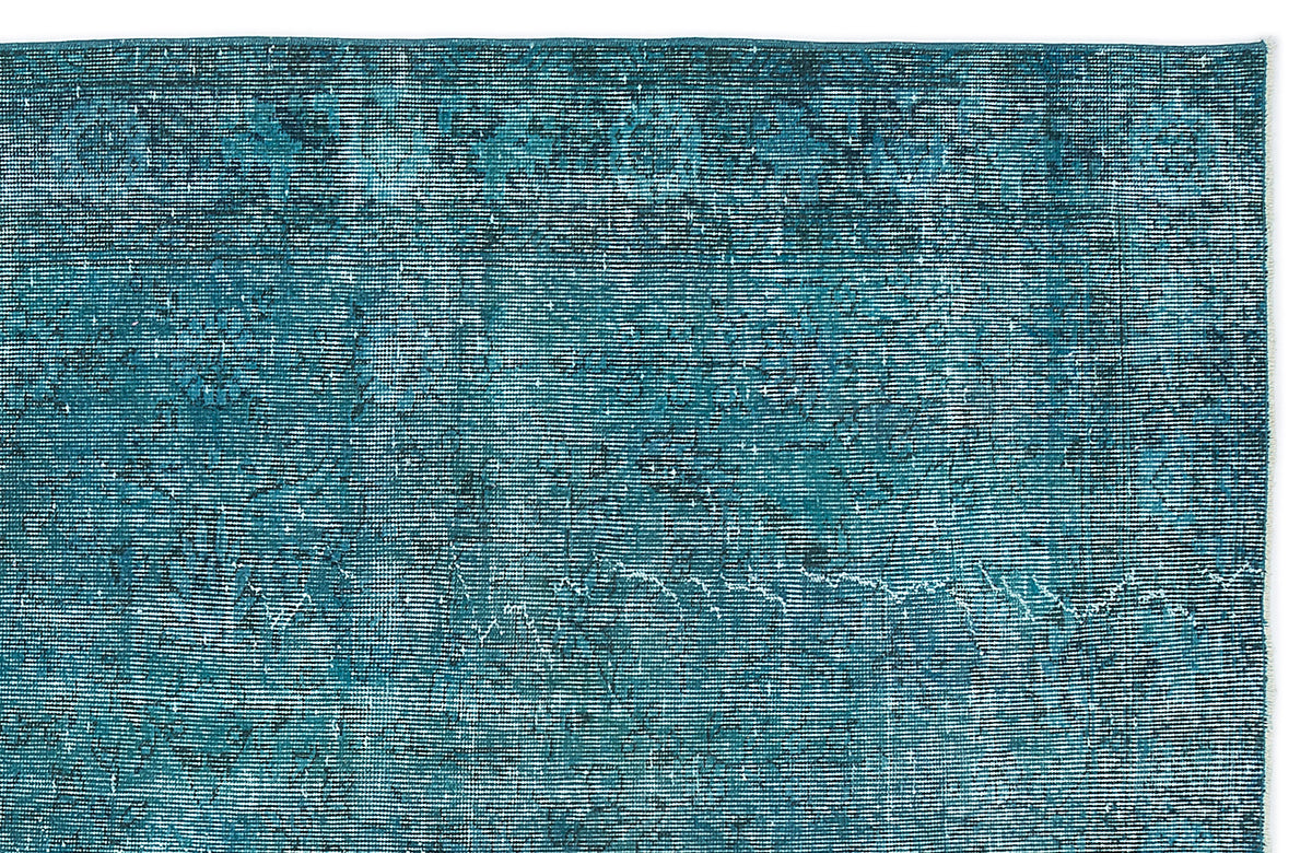 Teal and black distressed rug with a fine horizontal linear texture and faded vintage-style pattern.