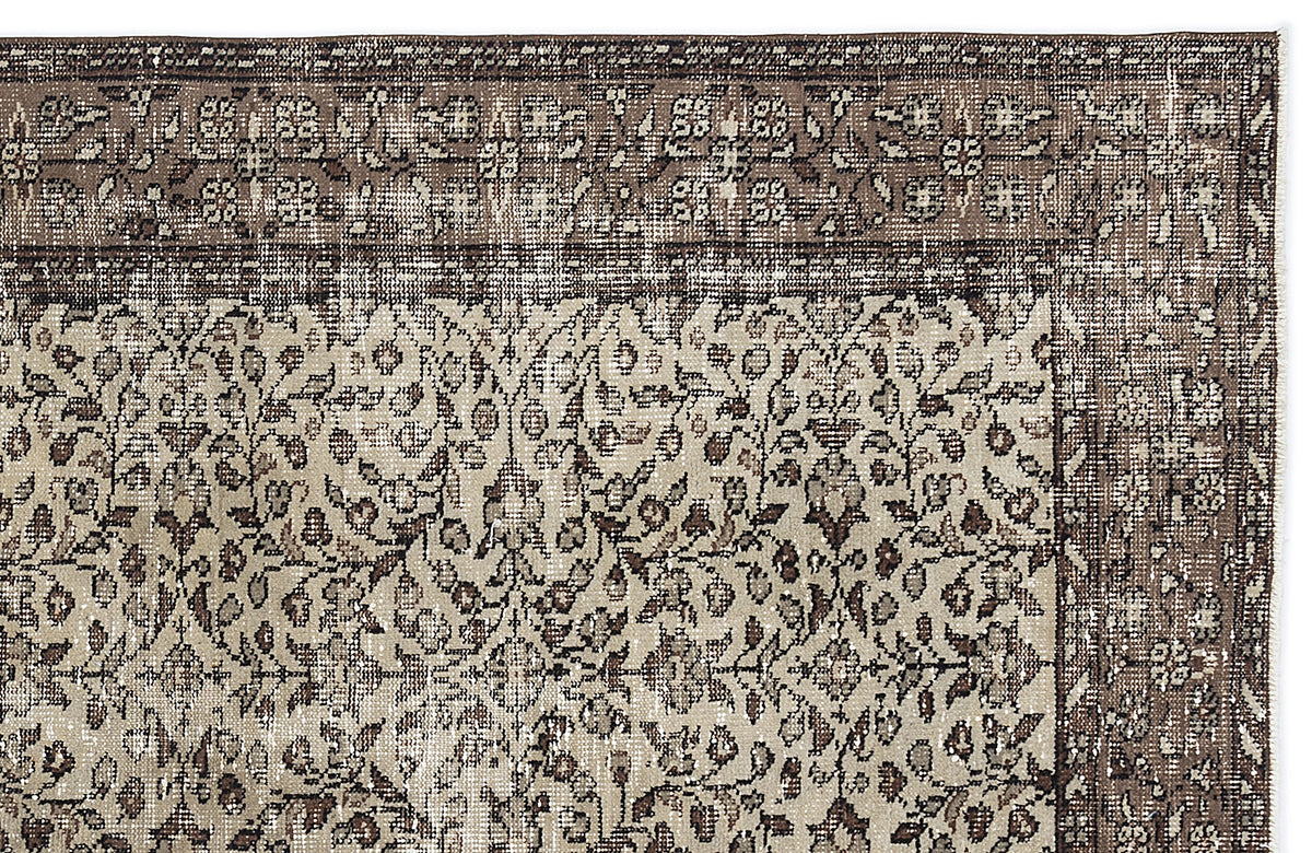 Brown and beige vintage-style rug with a dense floral pattern and a wide, ornate border.