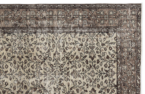 Load image 1 in gallery view. Brown and beige vintage-style rug with a dense floral pattern and a wide, ornate border.