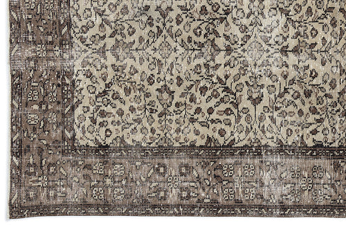 Load image 1 in gallery view. Beige and dark brown distressed rug with a traditional floral medallion pattern and a wide decorative border.
