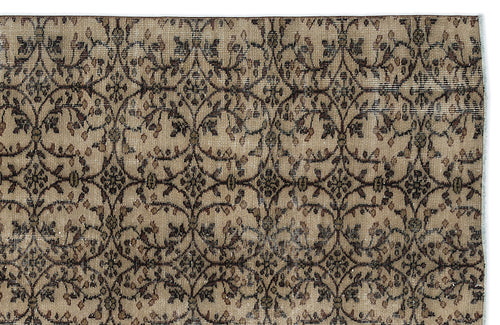 Load image 1 in gallery view. Beige and brown vintage-style rug with a repeating dark floral vine trellis pattern.