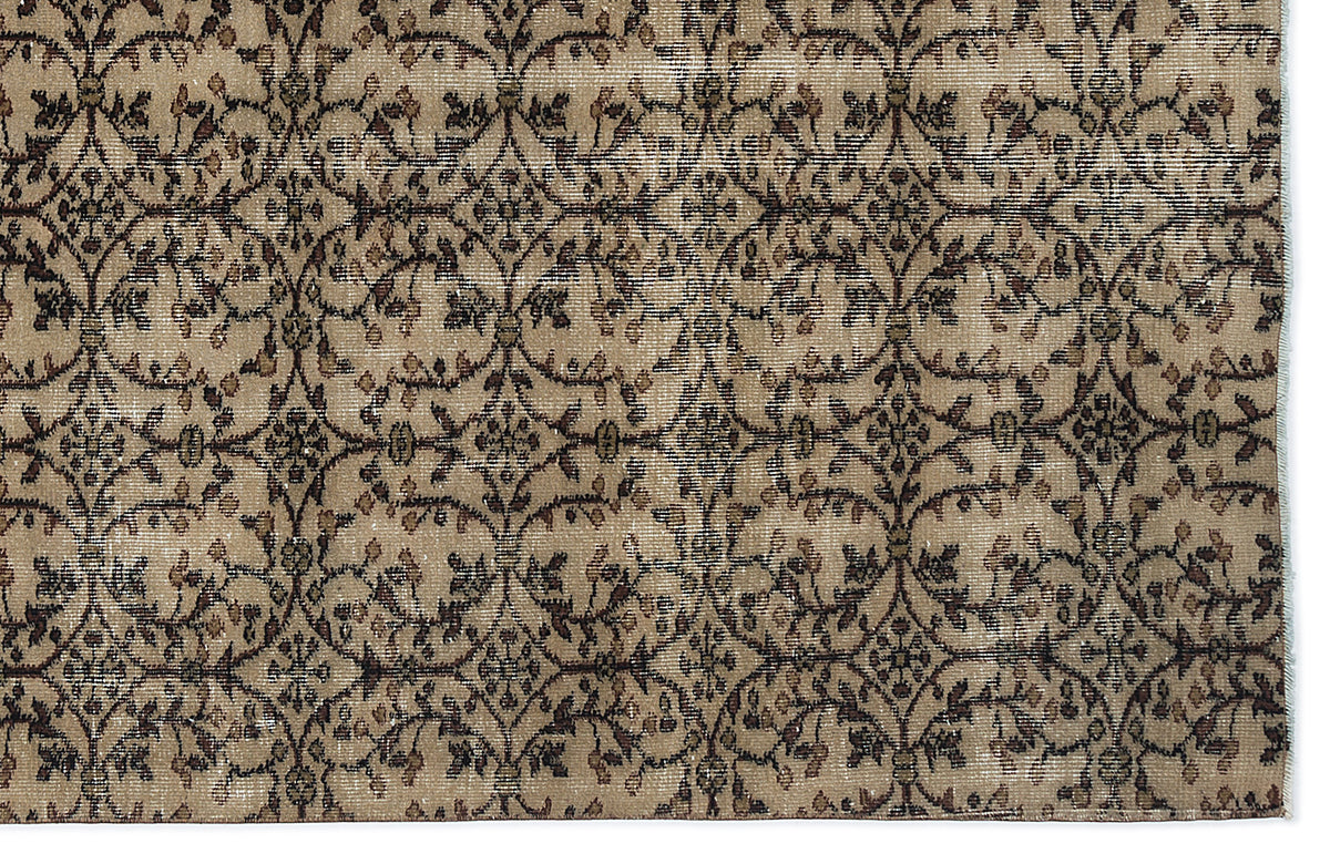 Beige and brown traditional rug with a repeating floral vine trellis pattern.