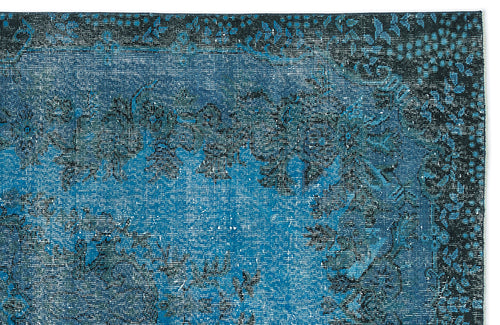 Load image 1 in gallery view. Deep blue and black distressed traditional rug with a faded floral medallion pattern.