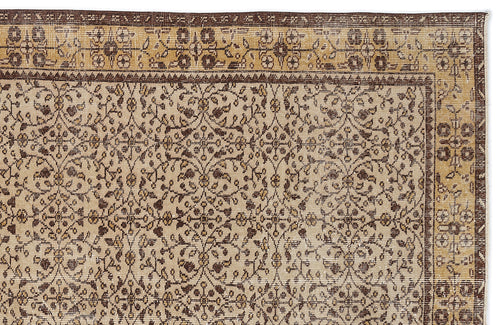 Load image 1 in gallery view. Beige and brown traditional rug with a repeating floral vine pattern and a decorative geometric border.