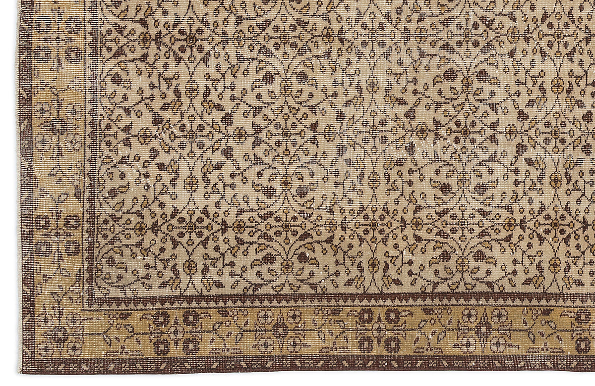 Beige and brown traditional rug with a repeating floral vine pattern and a wide decorative border.
