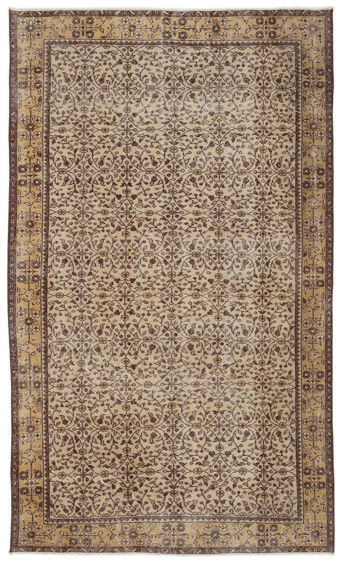 Distressed beige and brown vintage-style rug with an intricate floral vine pattern and a decorative border.