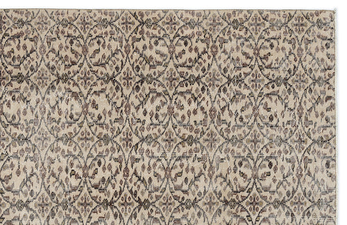 Load image 1 in gallery view. Beige and brown rug with a distressed, repeating lattice and floral medallion pattern.