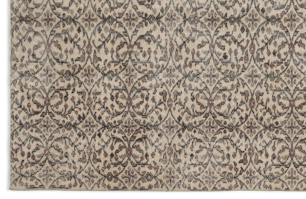 Beige and brown rug with a repeating lattice pattern of stylized floral medallions and distressed textures.