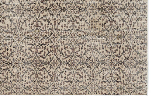 Load image 1 in gallery view. Beige and brown rug with a repeating distressed floral medallion pattern in a lattice arrangement.