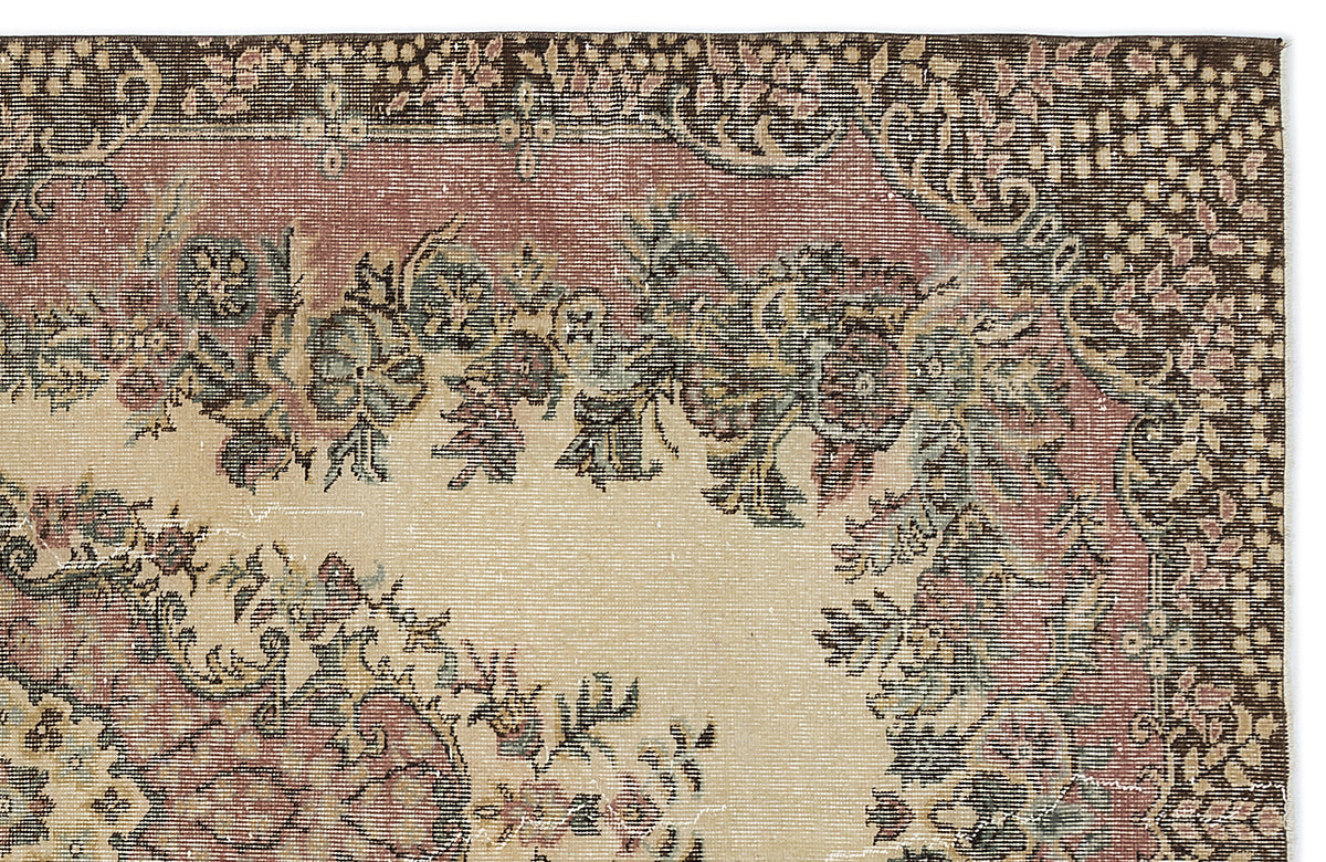 Beige, brown, and muted red traditional rug with a floral medallion pattern and a detailed geometric border.