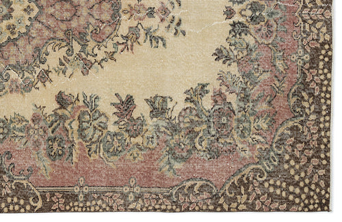 Load image 1 in gallery view. Distressed beige rug with a faded floral medallion pattern in muted red, green, and dark brown tones.