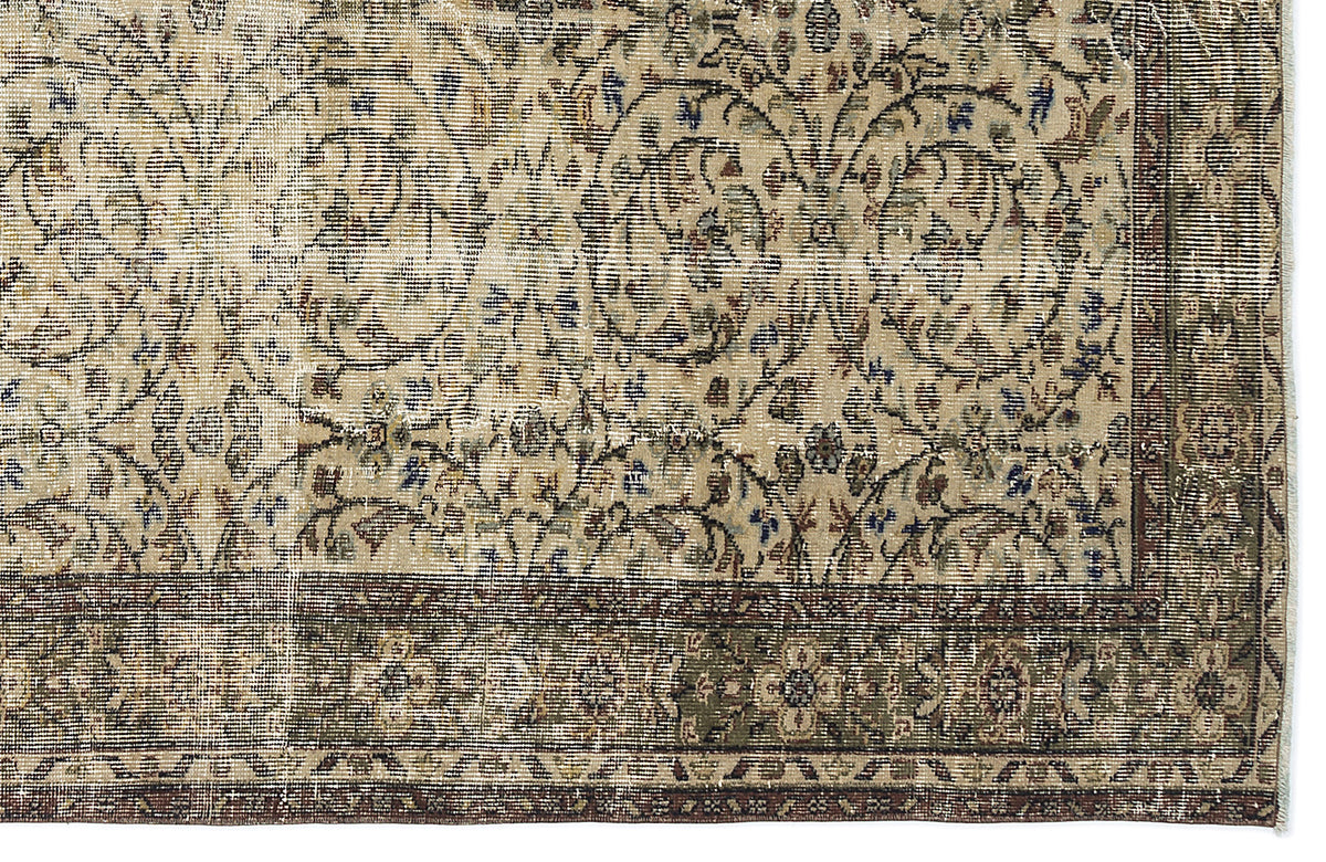Beige vintage-style rug with a distressed floral vine pattern and a dark olive green border.