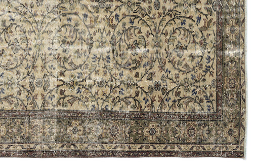 Load image 1 in gallery view. Beige vintage-style rug with a distressed floral vine pattern and a dark olive green border.