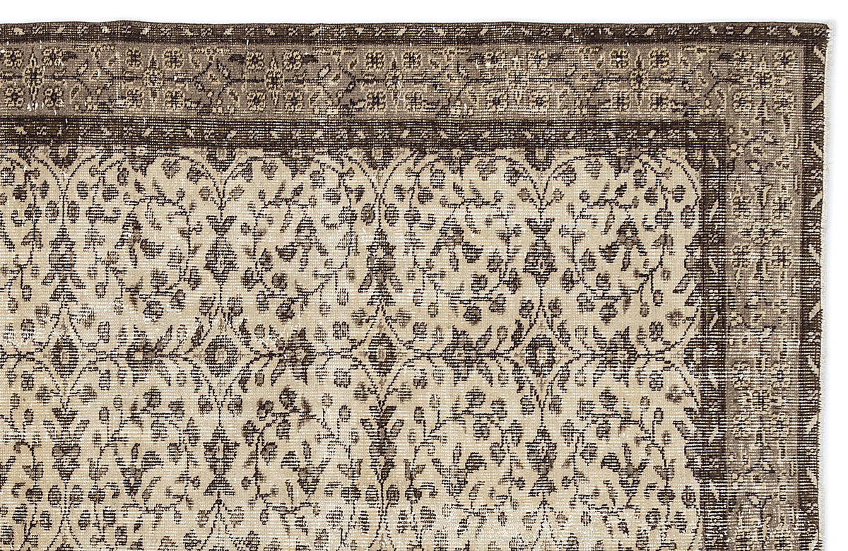 Dark brown and beige vintage-style rug with a traditional floral vine pattern and a decorative border.