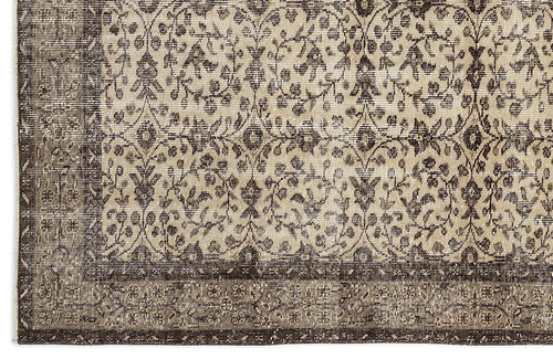Load image 1 in gallery view. Beige and dark brown rug with a distressed traditional floral medallion pattern and a wide decorative border.