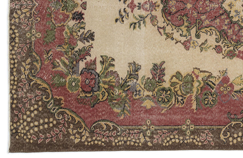 Load image 1 in gallery view. Beige, red, and green traditional rug with a floral medallion pattern and a dark brown border.