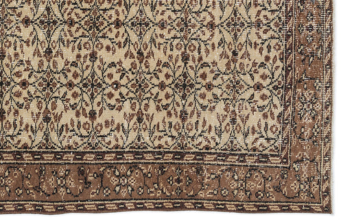 Load image 1 in gallery view. Beige and brown rug with a distressed traditional floral pattern and a wide decorative border.