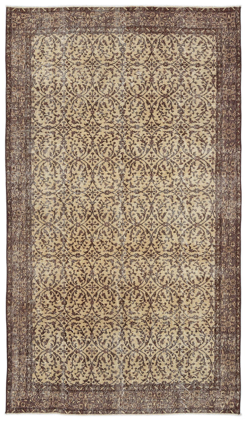 Load image 1 in gallery view. Brown and beige vintage-style rug with a repeating damask floral pattern and a distressed finish.