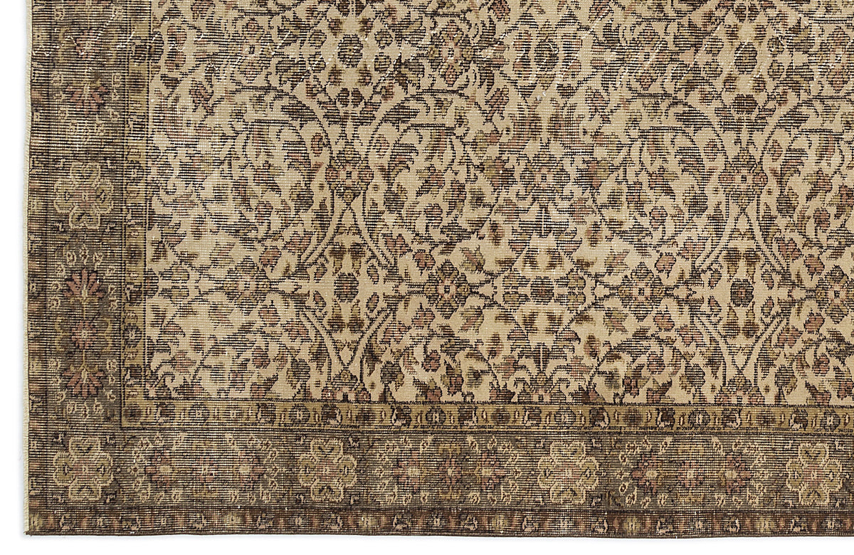 Beige and brown traditional rug with a distressed floral vine pattern and a detailed decorative border.