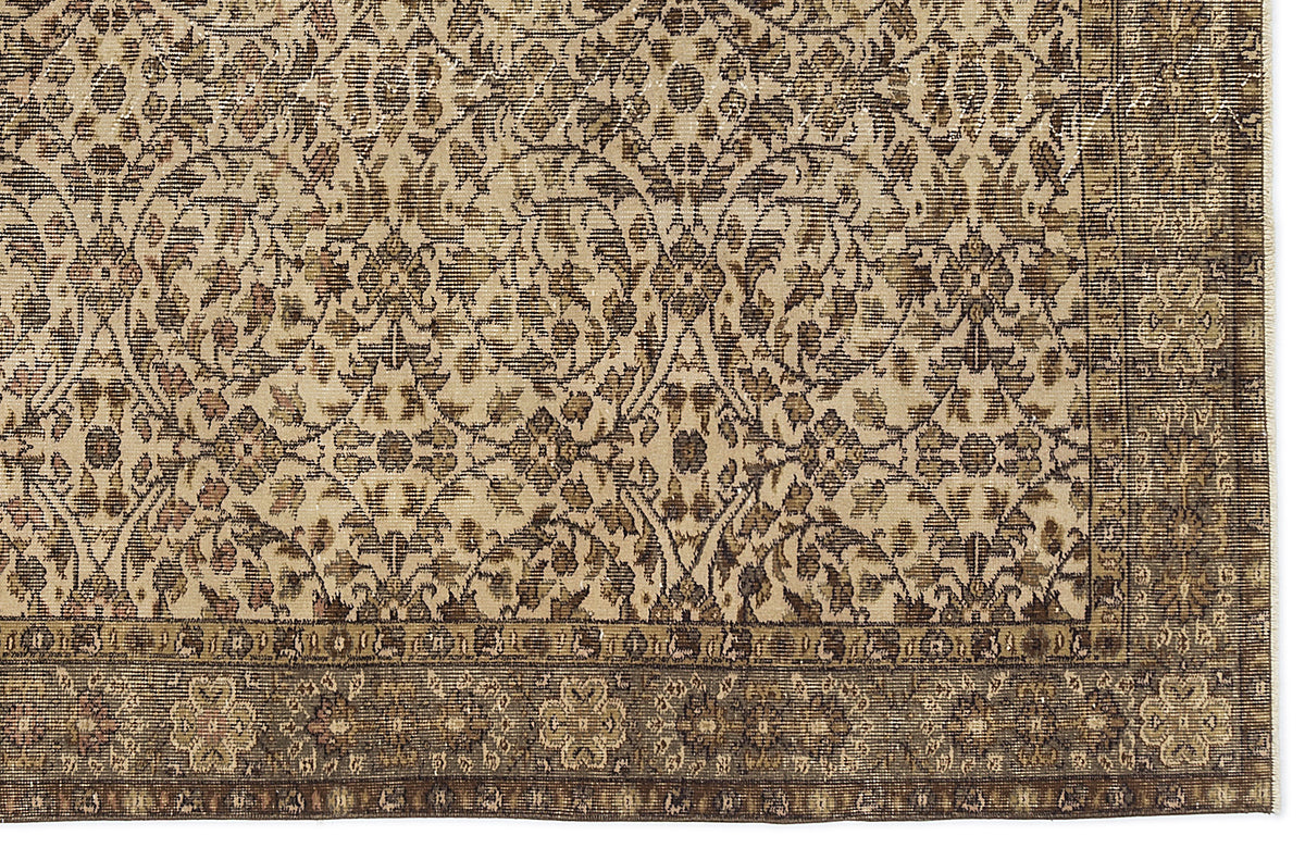 Beige and brown traditional rug with a dense, distressed floral medallion pattern and a wide, ornate border.