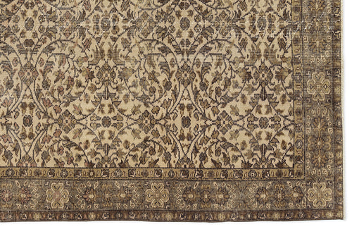 Load image 1 in gallery view. Beige and brown traditional rug with a dense, distressed floral medallion pattern and a wide, ornate border.