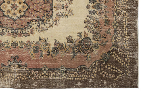 Load image 1 in gallery view. Distressed traditional rug with a cream center, floral medallion, and dark brown border with intricate geometric details.