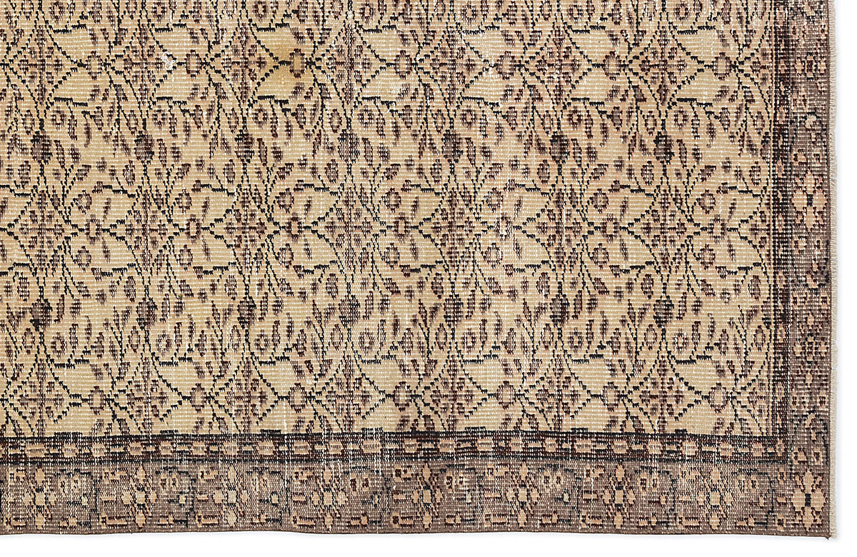 Beige and dark brown vintage-style rug with a repeating floral lattice pattern and a wide decorative border.